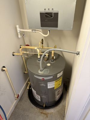 HVAC Guyz & Plumbing Inc — freshly installed Rheem electric water heater with new gas piping and flex conduit