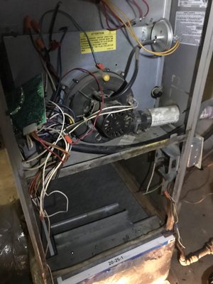 HVAC Guyz & Plumbing Inc — gas furnace with control board and blower motor exposed during diagnostic service